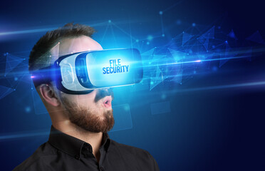 Businessman looking through Virtual Reality glasses, virtual security concept