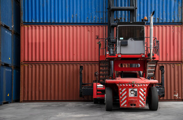 Forklift truck handling cargo shipping container box in logistic shipping yard with cargo container...