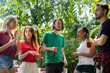 Happy friends fun at in the backyard - Young people camping at summer outdoor party and holidays - Youth friendship concept with guys and girls drinking wine at barbecue party