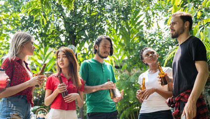 Happy friends fun at in the backyard - Young people camping at summer outdoor party and holidays - Youth friendship concept with guys and girls drinking wine at barbecue party