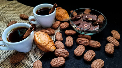Coffee with cinnamon and croissants for two