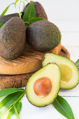 Haas avocado on a wooden board, natural products, selective focus
