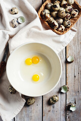 Broken quail eggs in a bowl.