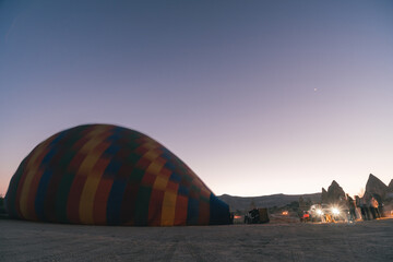 Goreme, TURKEY - August 27, 2020: Launching balloons, preparing for departure and receiving tourists on board. Early morning Sunrise in Cappadocia