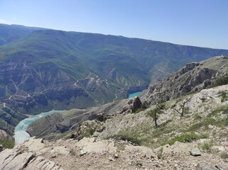 deep canyon with blue river and mountains