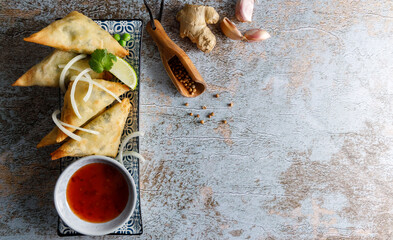 Homemade traditional vegetable Samosa. Homemade vegetable Samosa , street food filled with potato,onion,coriander,peas presented on a plate.