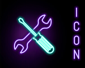 Glowing neon line Crossed screwdriver and wrench tools icon isolated on black background. Service tool symbol. Colorful outline concept. Vector