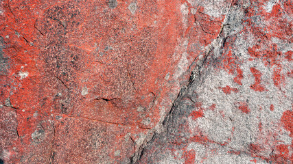 Natural stone surface with a red tint. Stone background.