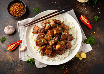 Chinese traditional cuisine sticky braised pork belly with rice on white plate