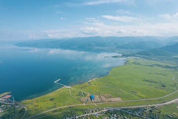 Summertime imagery of Lake Baikal is a rift lake located in southern Siberia, Russia Baikal lake summer landscape view from a cliff near Grandma's Bay. Drone's Eye View.