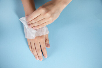 woman cleaning hands in napkin