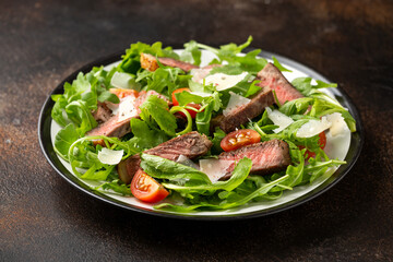 Italian Beef Tagliata salad with wild rocket, cherry tomatoes and parmesan cheese