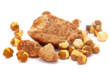 Micro close-up and details of Organic Indian roasted chana (Cicer arietinum)  with gud (jaggery)  isolated over white background.