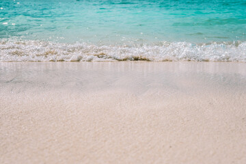 Natural natural background. Blue ocean with waves and white sand of the Maldives.