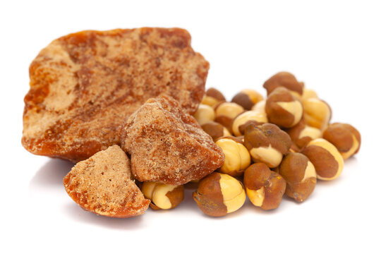 Micro close-up and details of Organic Indian roasted chana (Cicer arietinum)  with gud (jaggery)  isolated over white background.