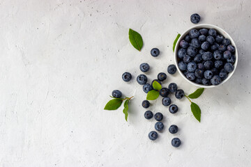 Blueberries in a cup on a white background