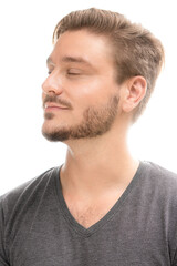Fototapeta premium Portrait of a young man with closed eyes on a white background