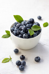 Blueberries in a cup on a white background