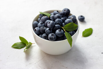 Blueberries in a cup on a white background