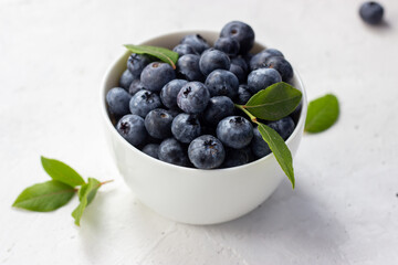 Blueberries in a cup on a white background