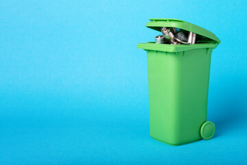 Waste batteries in a plastic container. Waste recycling. Environmental concept. Basket with...