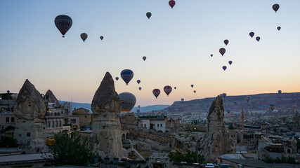 Fototapeta na wymiar Hot air balloons launch in the Goreme national park in Cappadocia, Turkey. Colorful balon flying over. Cappadocia's greatest tourist attraction is ballooning. 