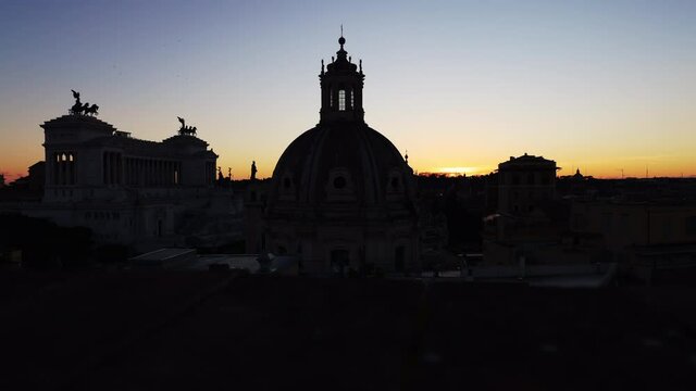 Timelapse of sunset over the Imperial Forums of Rome with the Altar of the Fatherland and the Dome of the church of the Most Holy Name of Mary and the Janiculum Hill in the background