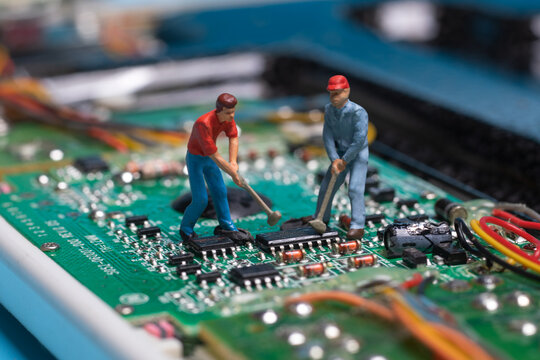 toy workers working on electronic chip, technology and development concept