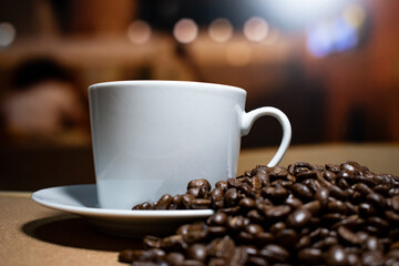 Coffee cup and saucer on a wooden table. Dark background.