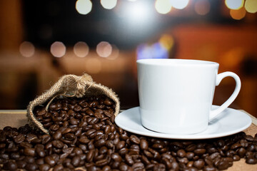 Coffee cup and saucer on a wooden table. Dark background.