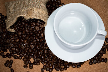 Cup of coffee full of coffee beans.