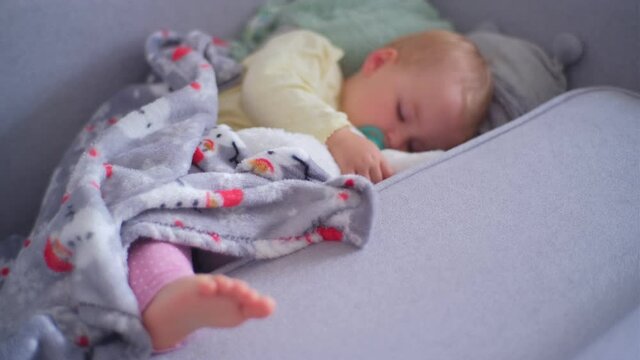 Adorable Cute Causian Toddler Girl Taking Afternoon Nap Sleeping Peacefully Under Blacket Cooling Her Foot