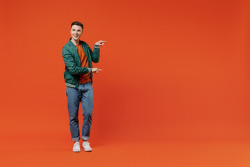 Full size body length smiling vivid happy young brunet man 20s wears red t-shirt green jacket...
