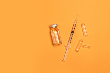 Coronavirus, flu or measles vaccine vial with syringe on yellow background, horizontal banner with copy space. Family immunization. International day against drug abuse