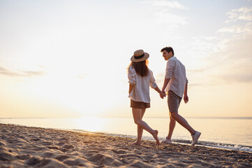 Full body back view young lovely couple two friends family man woman in casual clothes hold hands...