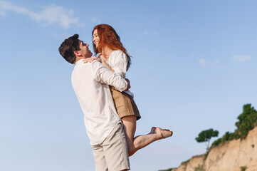 Side view fun happy young couple two friends family man woman in white clothes boyfriend hug hold...