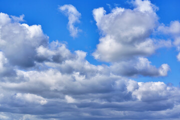 Naklejka na ściany i meble White cumulus clouds on blue sky background, natural phenomenon