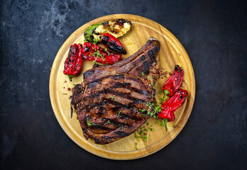 Traditional barbecue dry aged wagyu cote de boeuf beef steaks with zucchini and chili served as top...