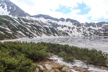 The Valley of the Five Polish Ponds in the High Tatras at the beginning of June, partially covered with remnants of snow