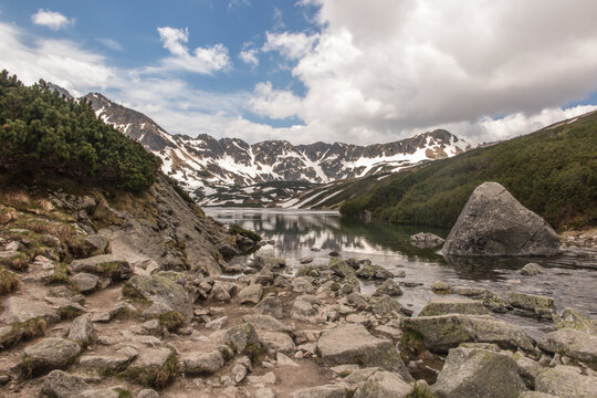 The Valley of the Five Polish Ponds in the High Tatras at the beginning of June, partially covered with remnants of snow