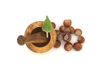 Hazelnuts and wooden rustic-style mortar and pestle