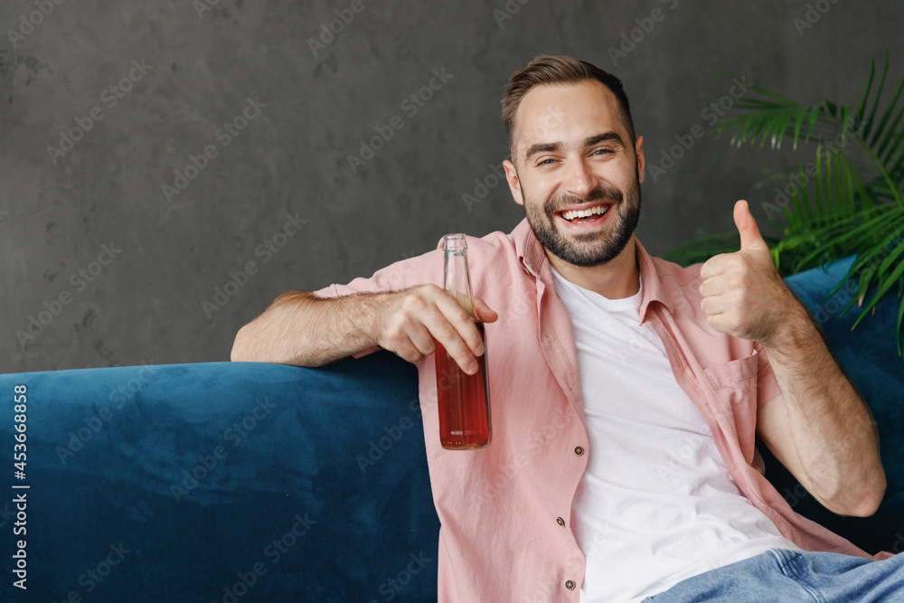 Canvas Prints young smiling happy man in casual clothes hold popcorn snack bottle drink beer watch movie show thum