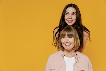 Two young minded smiling happy fun cheerful daughter mother together couple women in casual beige...