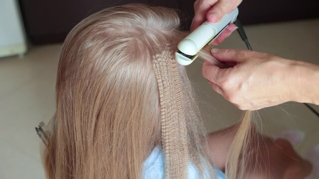 Mother makes blonde hair to daughter