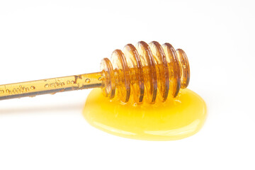 spoon with fresh honey spilled on a white background. organic vitamin food