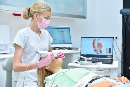 Orthodontist scaning patient with dental intraoral scanner