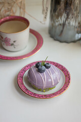 lavender cake on blue table with flowers