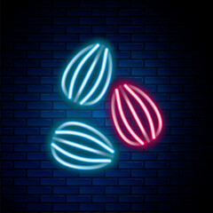 Glowing neon line Seeds of a specific plant icon isolated on brick wall background. Colorful outline concept. Vector