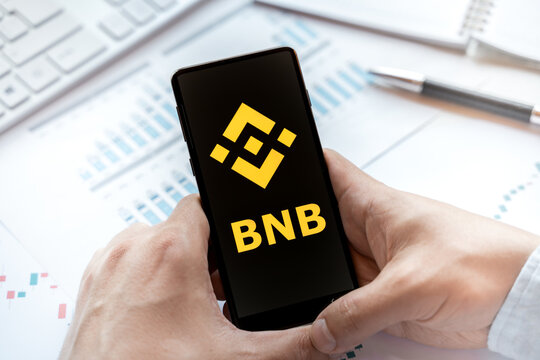 Russia Moscow 24.06.21 Logo of Binance coin in mobile phone. Cryptocurrency BNB token. Trading blockchain platform to buy,sell on decentralized exchange DEX. Digital money.Business,investing