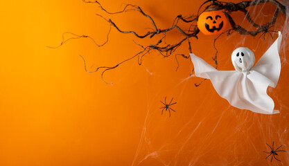 Halloween ghosts with funny pumpkin on orange background. Happy halloween holiday concept. Handmade...